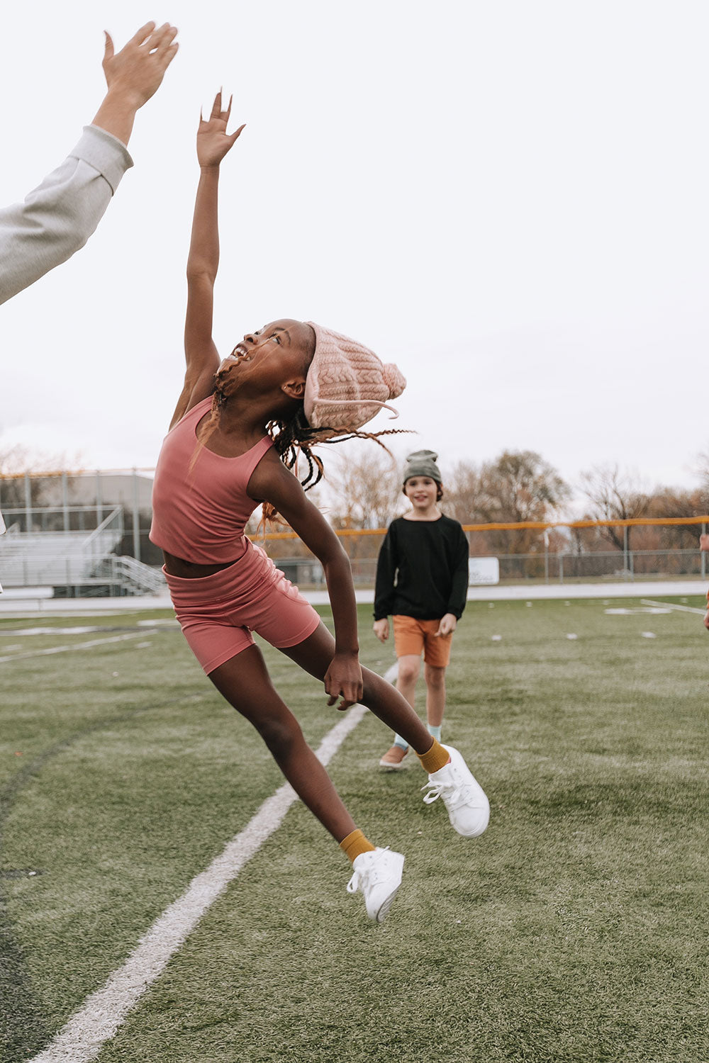 Young girl wearing Everyway kids activewear. Featuring Dusty Rose.