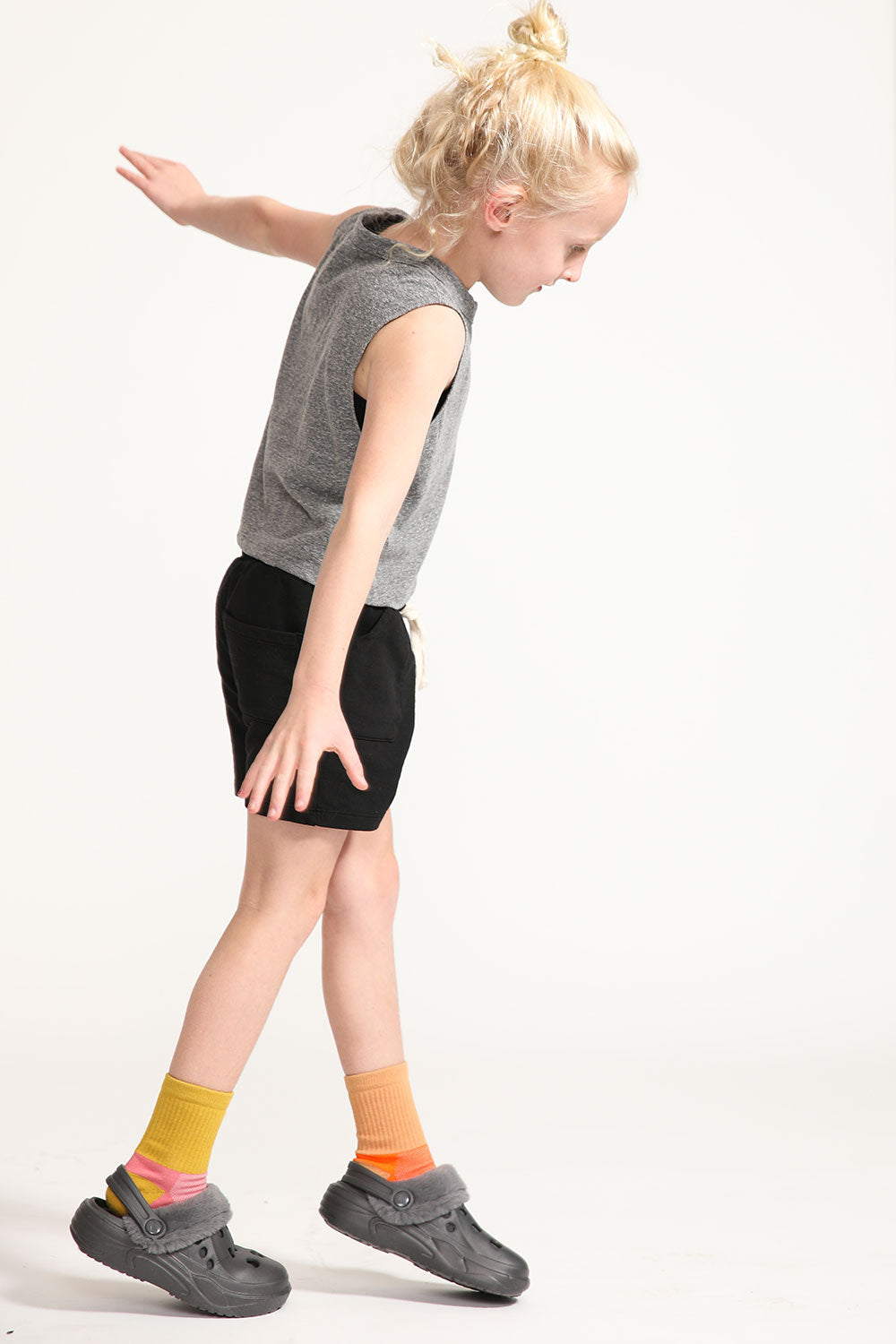 Young girl wearing Everyway kids activewear. Featuring Daily Tank Top in Heathered Gray.