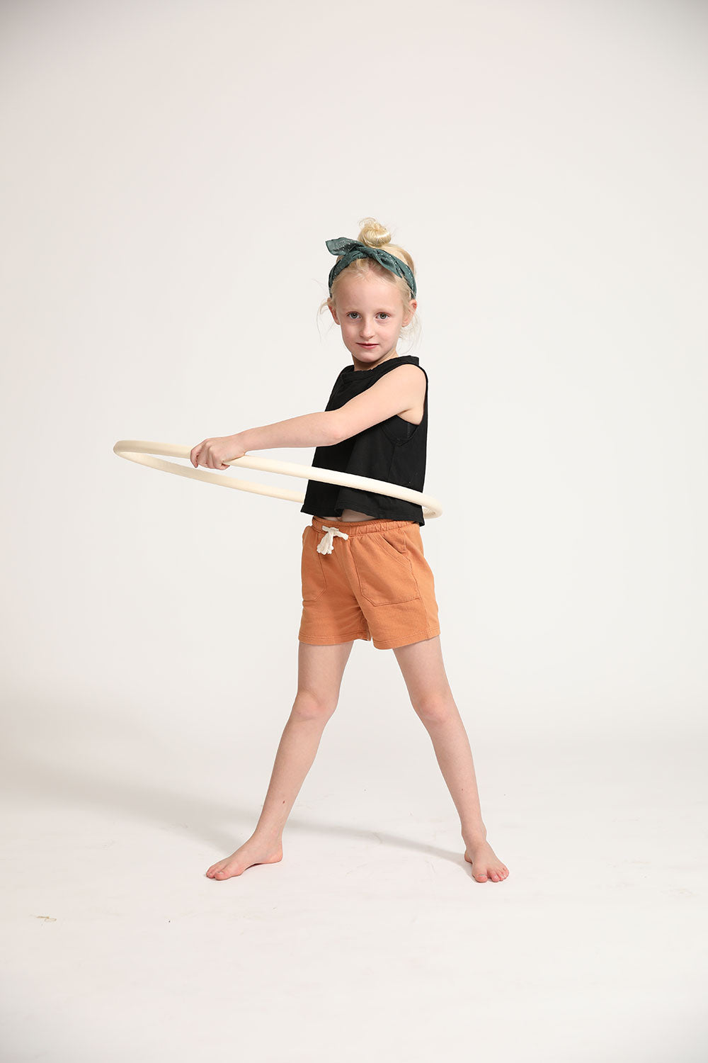 Young girl wearing Everyway kids activewear. Featuring Daily Tank Top in black.