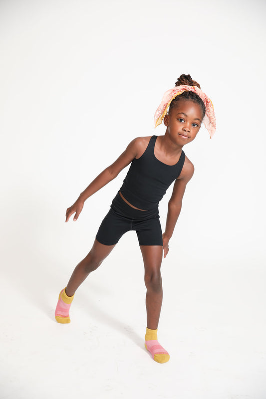 Young girl wearing Everyway kids activewear. Featuring Long Line Crop in Black.