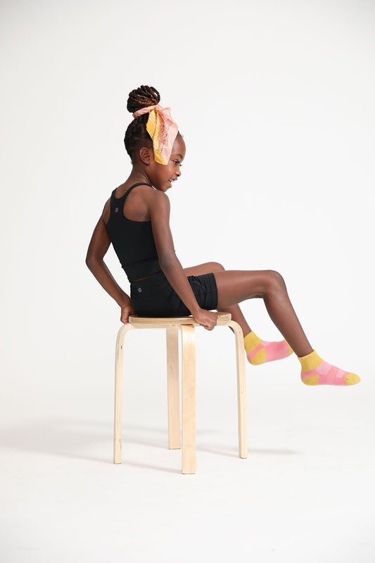 Young girl wearing Everyway kids activewear. Featuring Long Line Crop in Black.