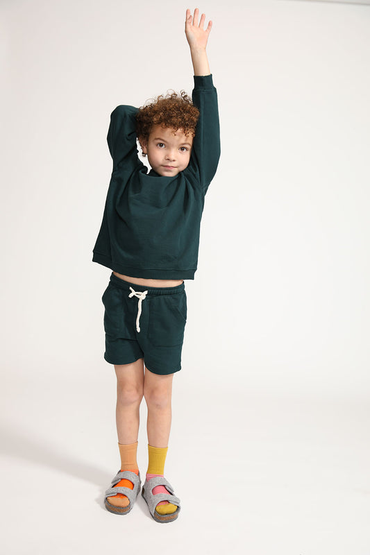 Young boy wearing Everyway kids activewear. Featuring Core Sweat Shirt in Pine.