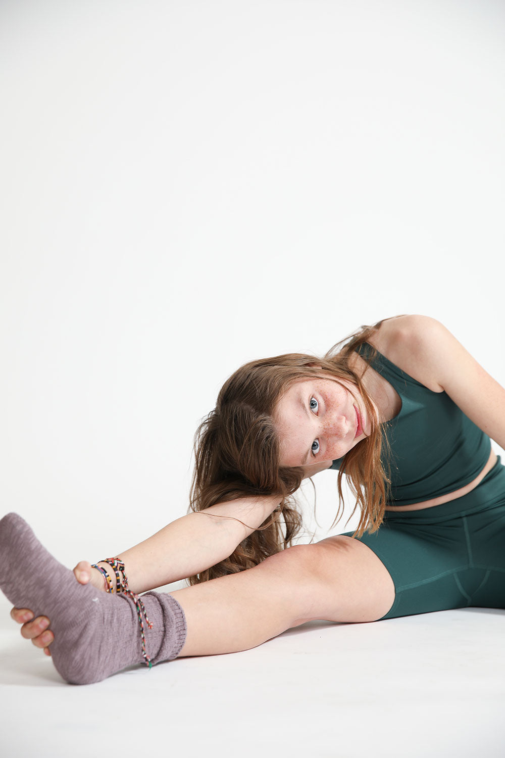 Young girl wearing Everyway kids activewear. Featuring Cycle Shorts in Pine.
