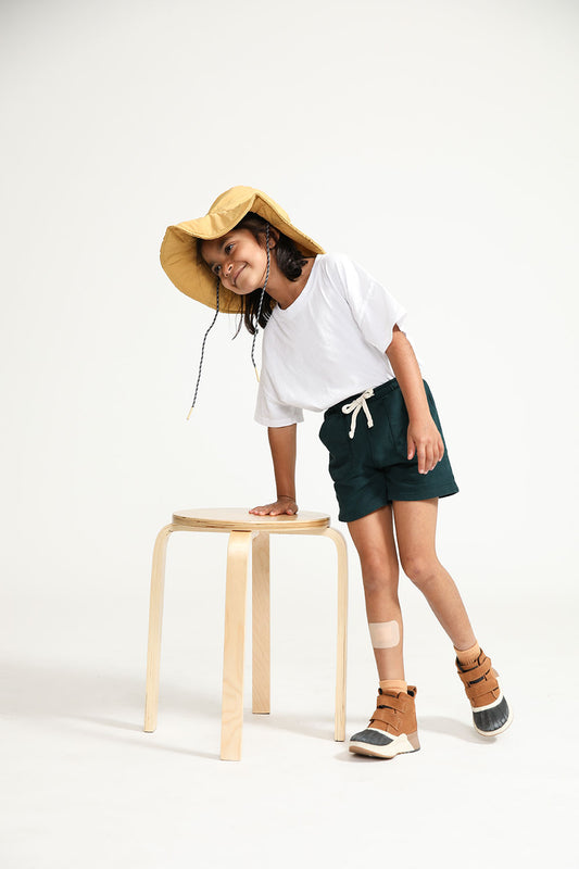 Young girl wearing Everyway kids activewear. Featuring Daily Tee in White.