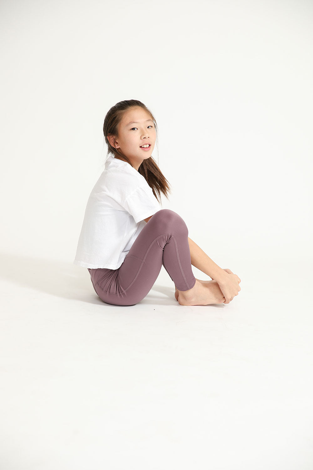 Young girl wearing Everyway kids activewear. Featuring Daily Tee in White.