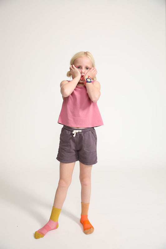 Young girl wearing Everyway kids activewear. Featuring Core Sweat Shorts in Plum.