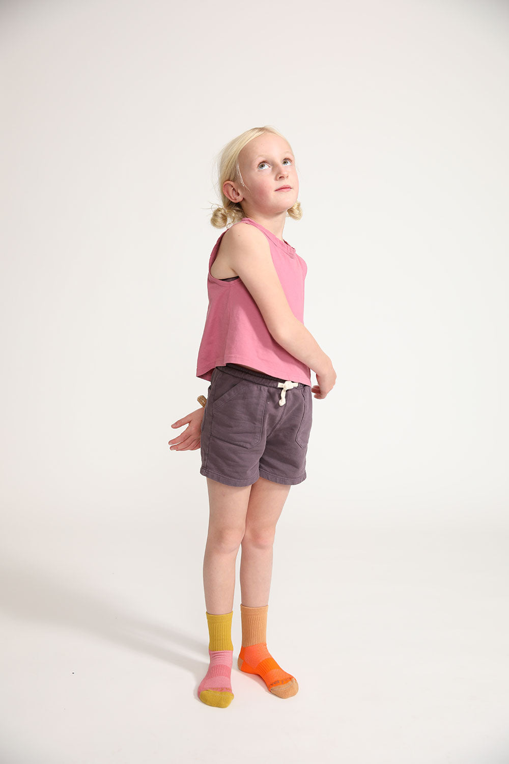 Young girl wearing Everyway kids activewear. Featuring Core Sweat Shorts in Plum.