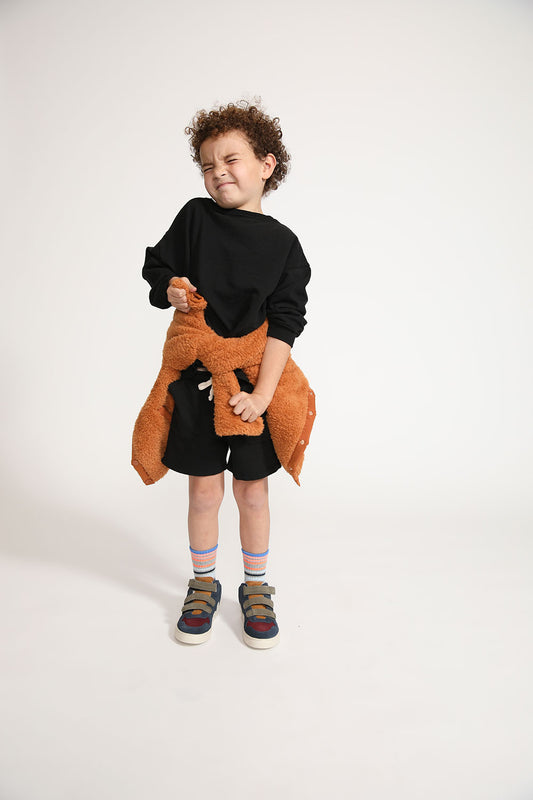 Young boy wearing Everyway kids activewear. Featuring Core Sweat Shirt in Black.
