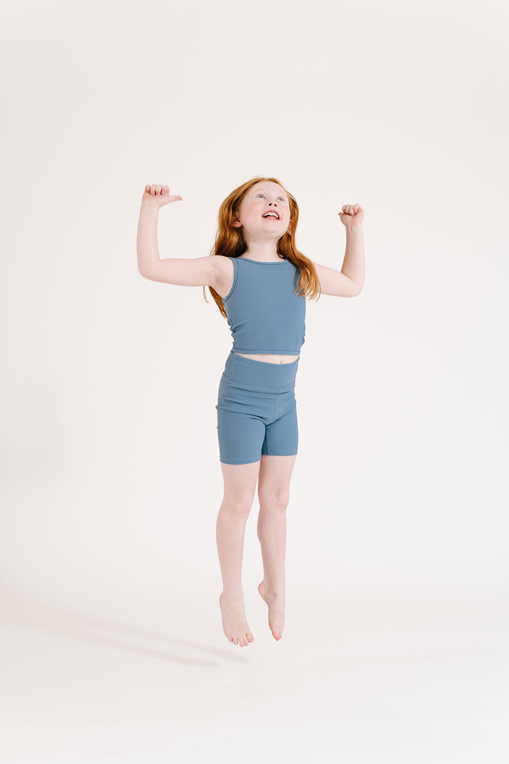 Young girl wearing Everyway kids activewear. Featuring Ribbed Cycle Shorts in Cornflower.