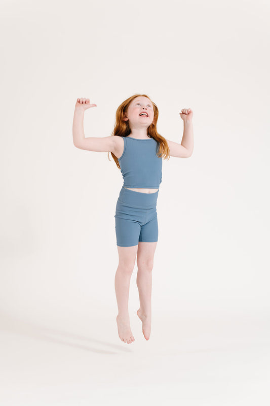 Young girl wearing Everyway kids activewear. Featuring Ribbed Cycle Shorts in Cornflower.