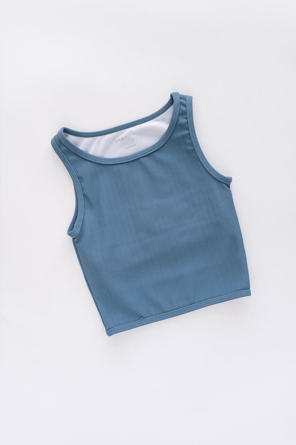 Young girl wearing Everyway kids activewear. Featuring Longline Crop in Cornflower.