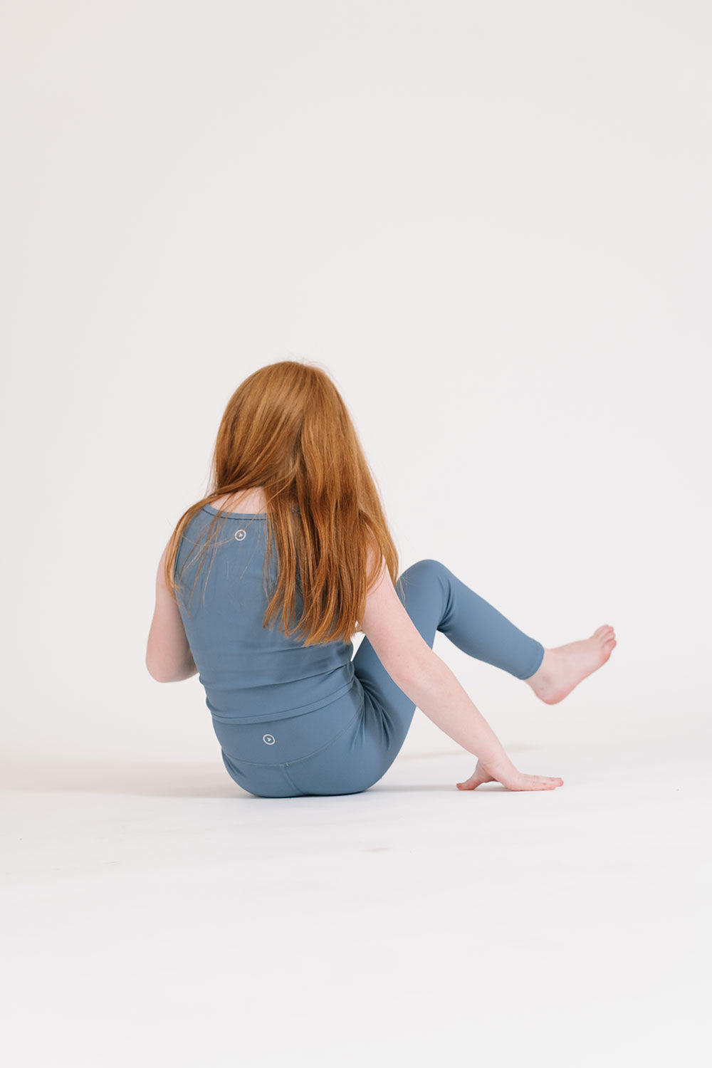 Young girl wearing Everyway kids activewear. Featuring Longline Crop in Cornflower.