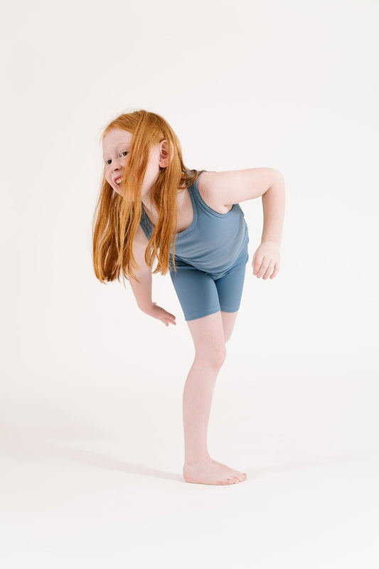 Young girl wearing Everyway kids activewear. Featuring Ribbed Cycle Shorts in Cornflower.