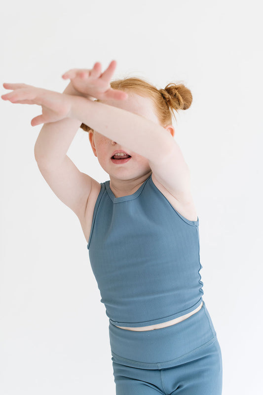 Young girl wearing Everyway kids activewear. Featuring Longline Crop in Cornflower.