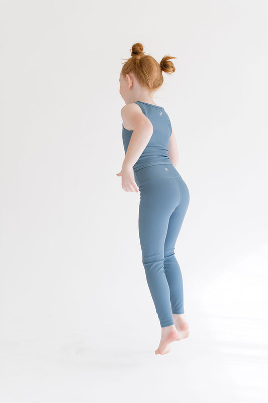 Young girl wearing Everyway kids activewear. Featuring Longline Crop in Cornflower.