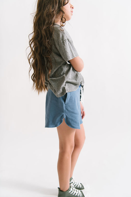 Young girl wearing Everyway kids activewear. Featuring Cloud Shorts in Harbor.
