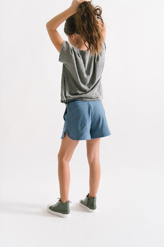 Young girl wearing Everyway kids activewear. Featuring Cloud Shorts in Harbor.