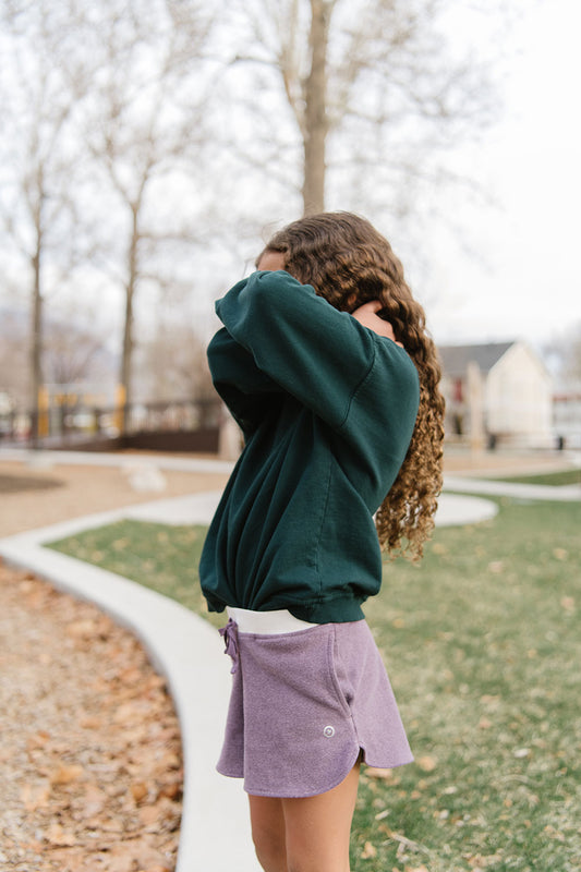 Young girl wearing Everyway kids activewear. Featuring Cloud Shorts in Plum.