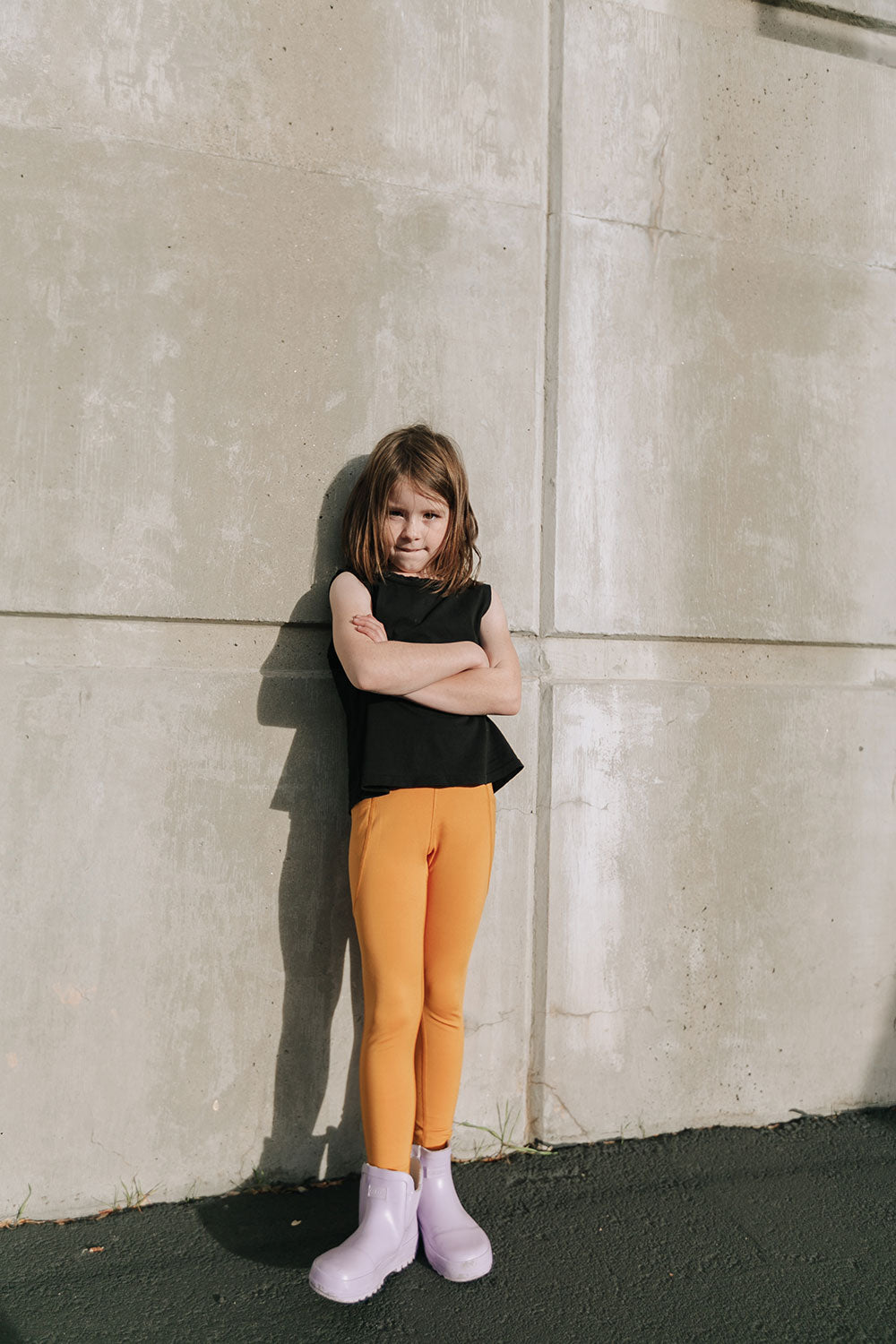 Young girl wearing Everyway kids activewear. Featuring Daily Tank Top in black.