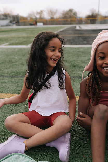 Young girl wearing Everyway kids activewear. Featuring Daily Tank Top in White.