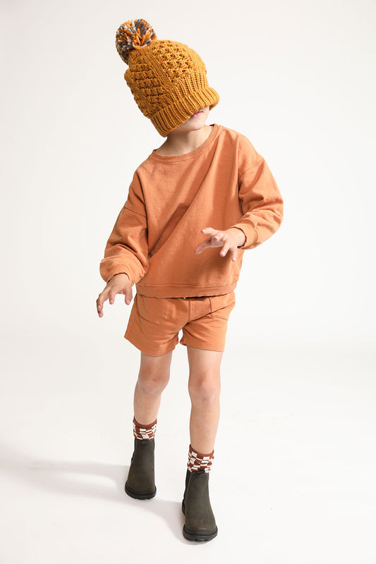 Young boy wearing Everyway kids activewear. Featuring Core Sweat Shirt in Meerkat.