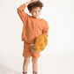 Young boy wearing Everyway kids activewear. Featuring Core Sweat Shorts in Meerkat.