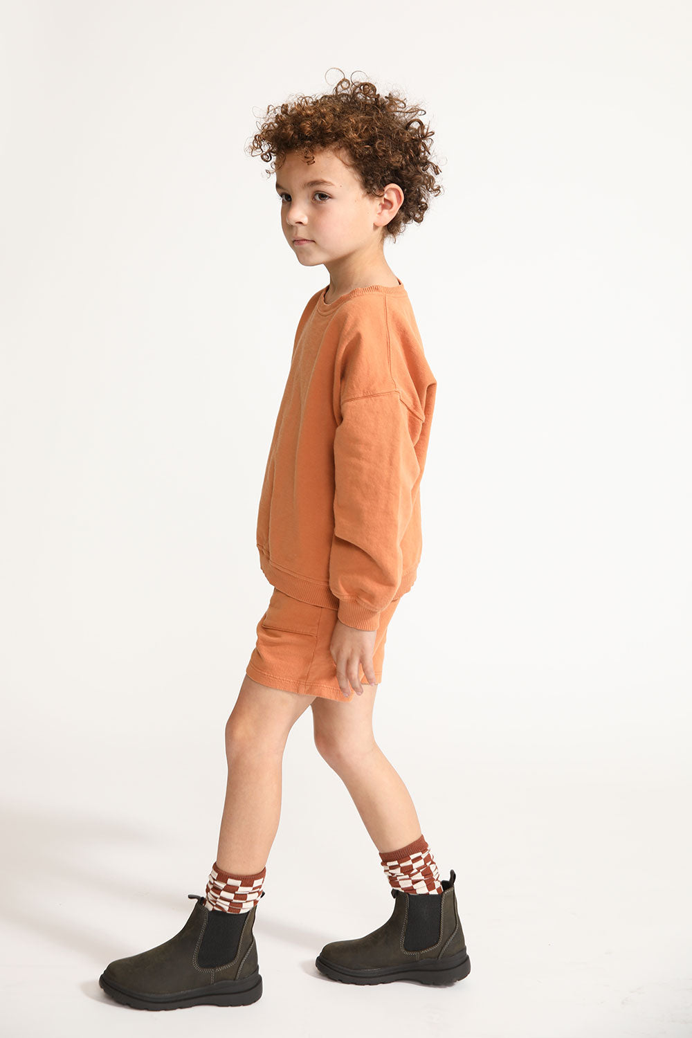 Young boy wearing Everyway kids activewear. Featuring Core Sweat Shirt in Meerkat.