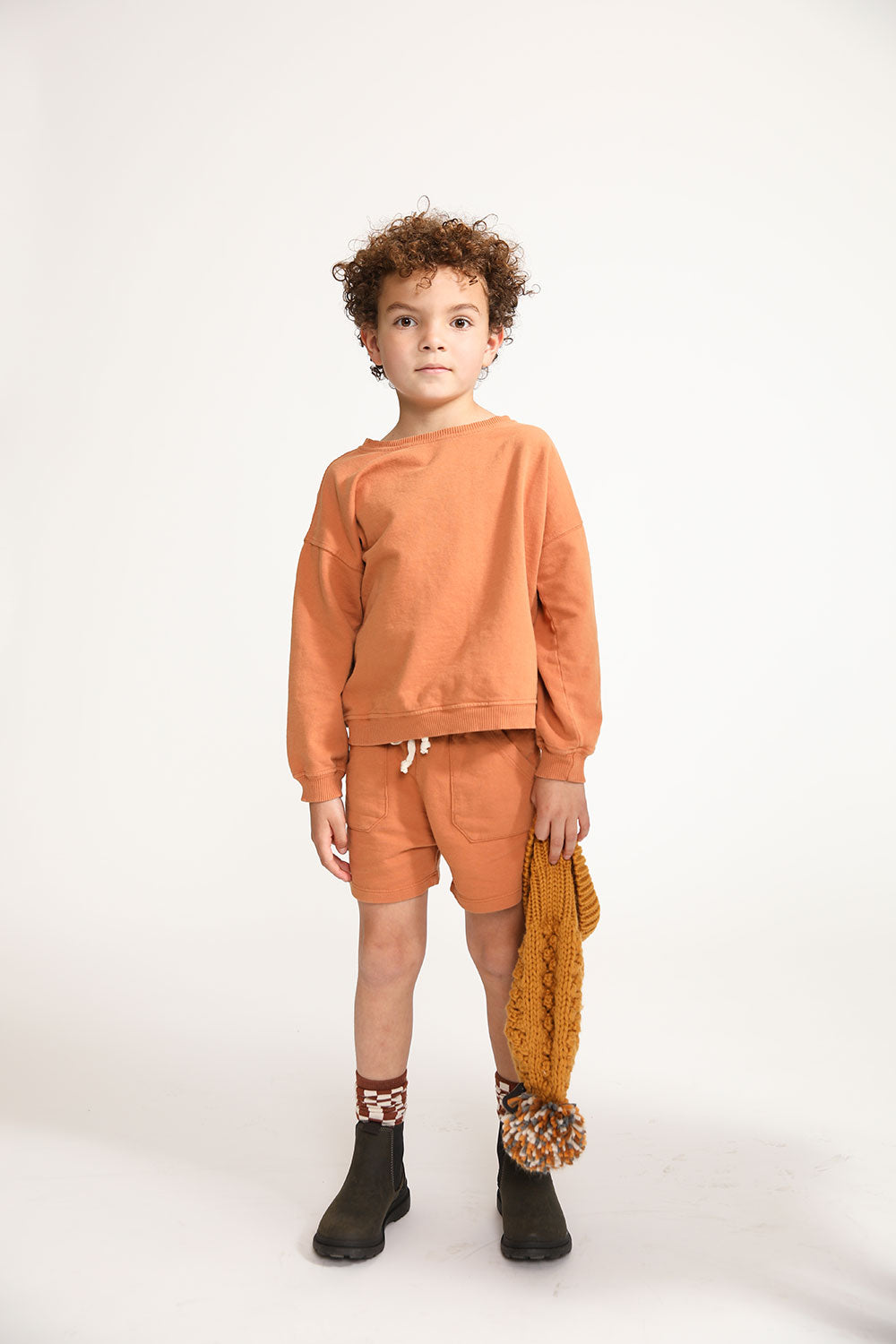 Young boy wearing Everyway kids activewear. Featuring Core Sweat Shirt in Meerkat.