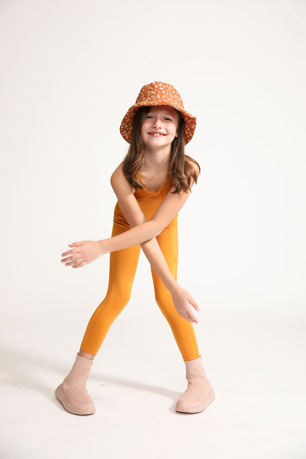 Young girl wearing Everyway kids activewear. Featuring Inca Gold Longline Crop and All Day Leggings.