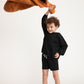 Young boy wearing Everyway kids activewear. Featuring Core Sweat Shirt in Black.