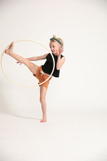 Young girl wearing Everyway kids activewear. Featuring Daily Tank Top in black.