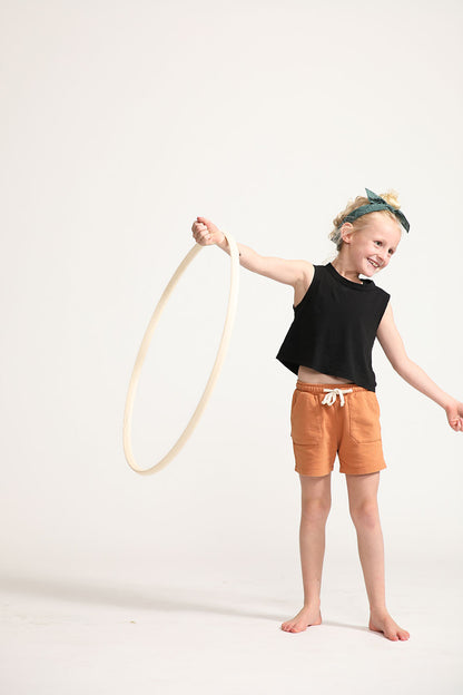 Young girl wearing Everyway kids activewear. Featuring Daily Tank Top in black.