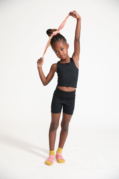 Young girl wearing Everyway kids activewear. Featuring Cycle Shorts in Black.