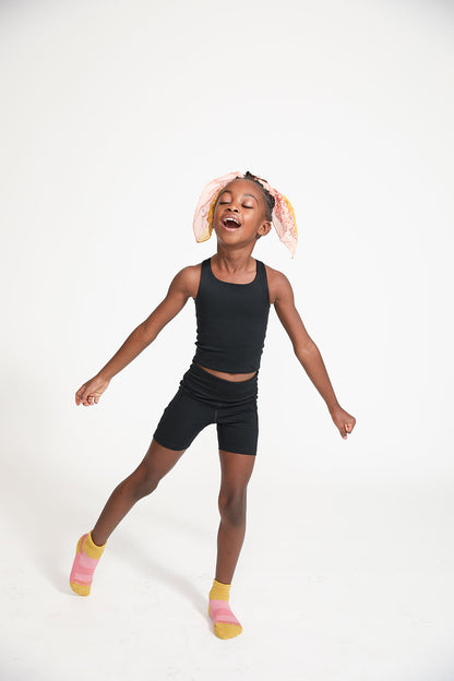 Young girl wearing Everyway kids activewear. Featuring Cycle Shorts in Black.