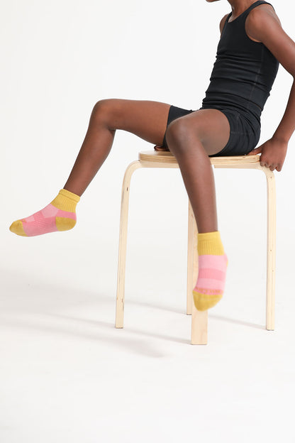 A young girl wearing crew socks from Everyway kids activewear.