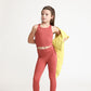 Young girl wearing Everyway kids activewear. Featuring Long Line Crop in Spice.