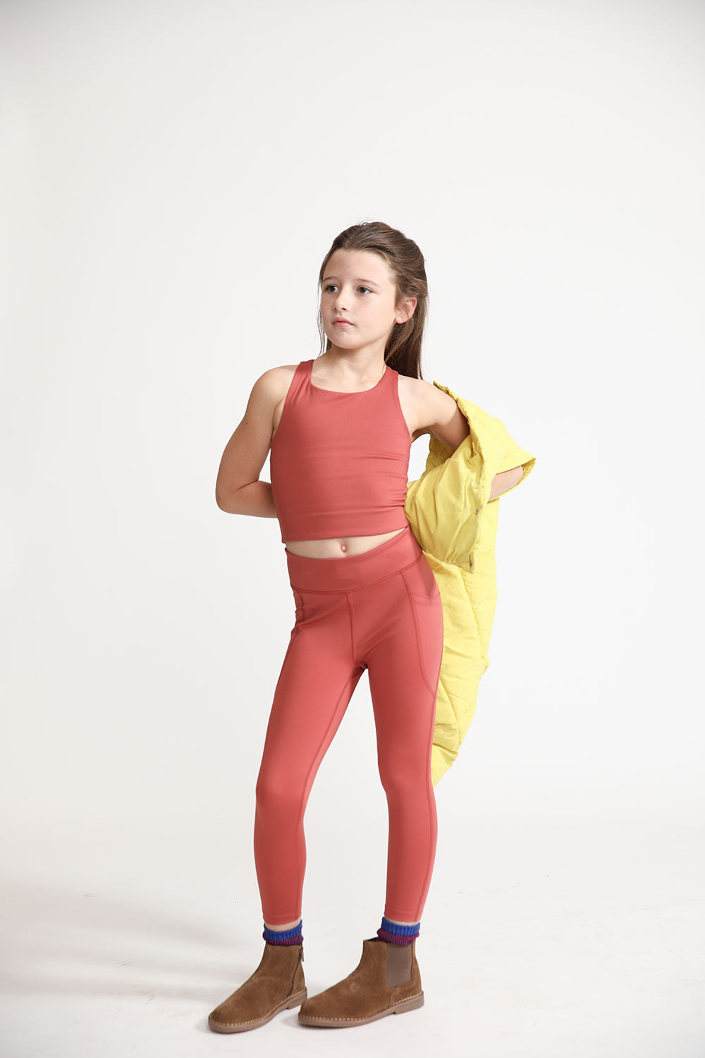 Young girl wearing Everyway kids activewear. Featuring Long Line Crop in Spice.