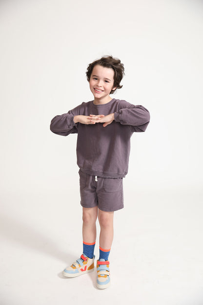 Young boy wearing Everyway kids activewear. Featuring Core Sweat Shirt in Plum