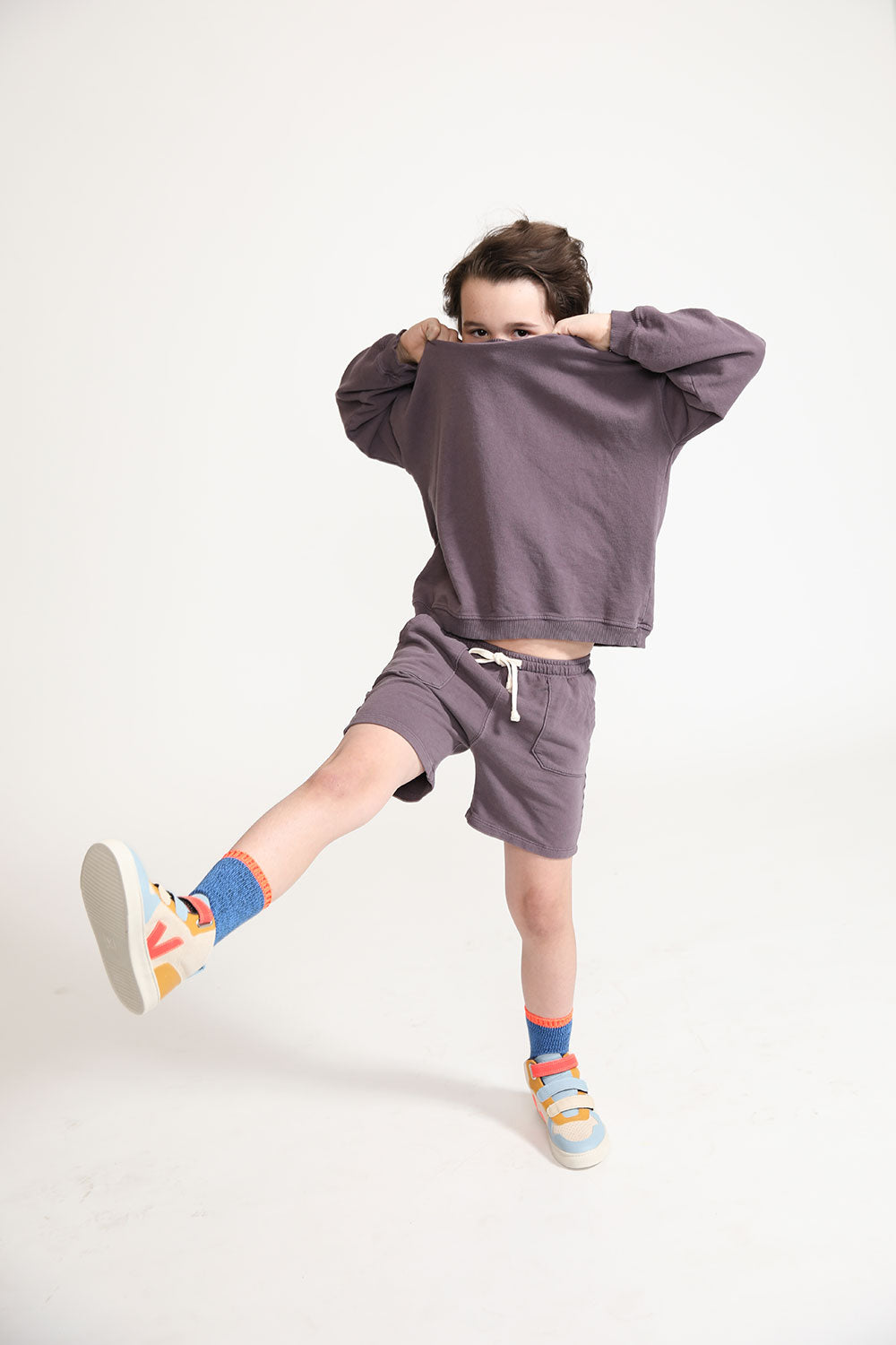 Young boy wearing Everyway kids activewear. Featuring Core Sweat Shirt in Plum