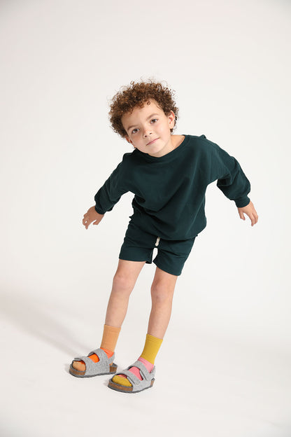 Young boy wearing Everyway kids activewear. Featuring Core Sweat Shirt in Pine.