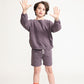 Young boy wearing Everyway kids activewear. Featuring Core Sweat Shorts in Plum.