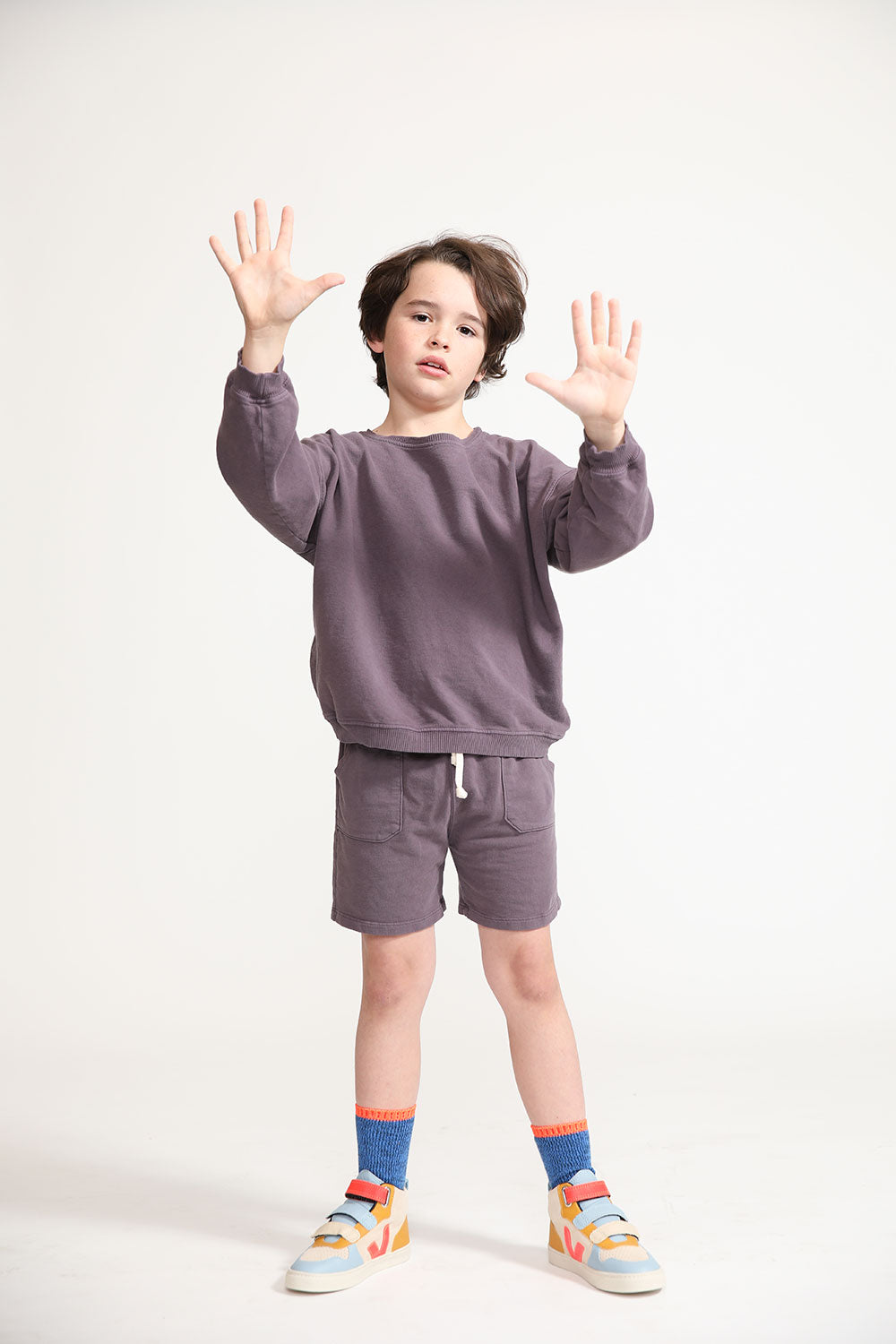Young boy wearing Everyway kids activewear. Featuring Core Sweat Shorts in Plum.