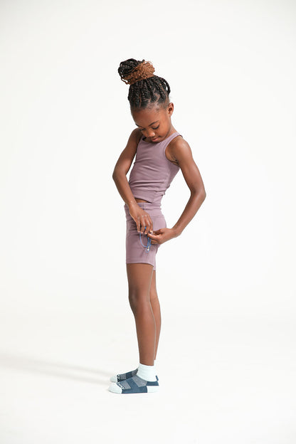 Young girl wearing Everyway kids activewear. Featuring Long Line Crop in Plum.