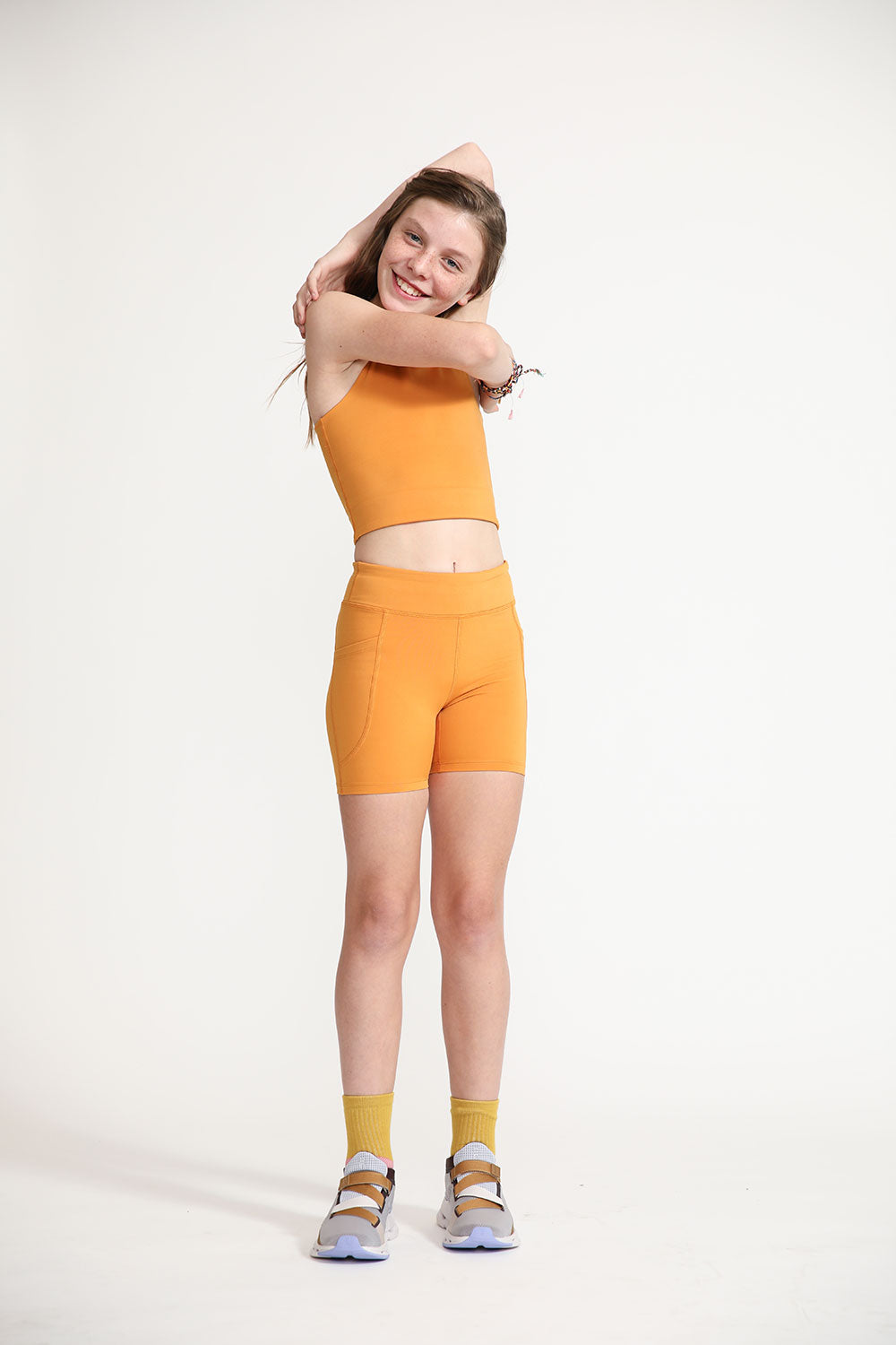 Young girl wearing Everyway kids activewear. Featuring Cycle Shorts in Inca Gold.