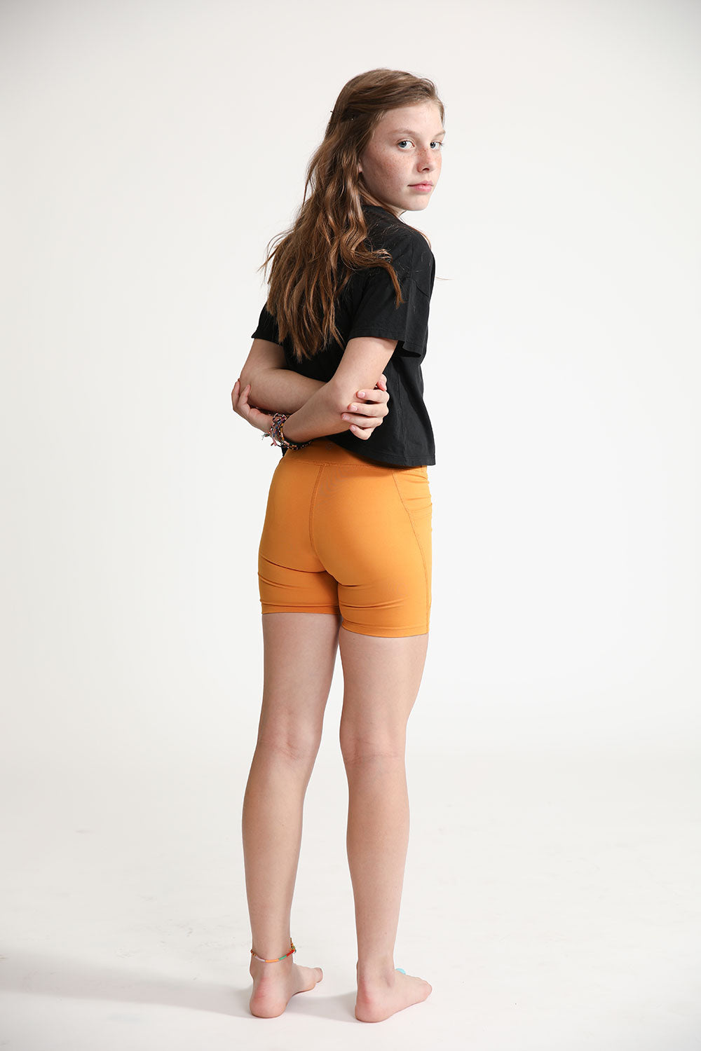 Young girl wearing Everyway kids activewear. Featuring Cycle Shorts in Inca Gold.