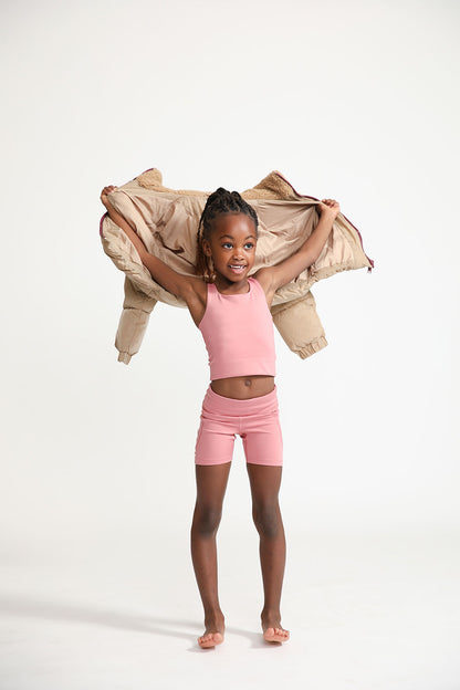 Young girl wearing Everyway kids activewear. Featuring Dusty Rose.