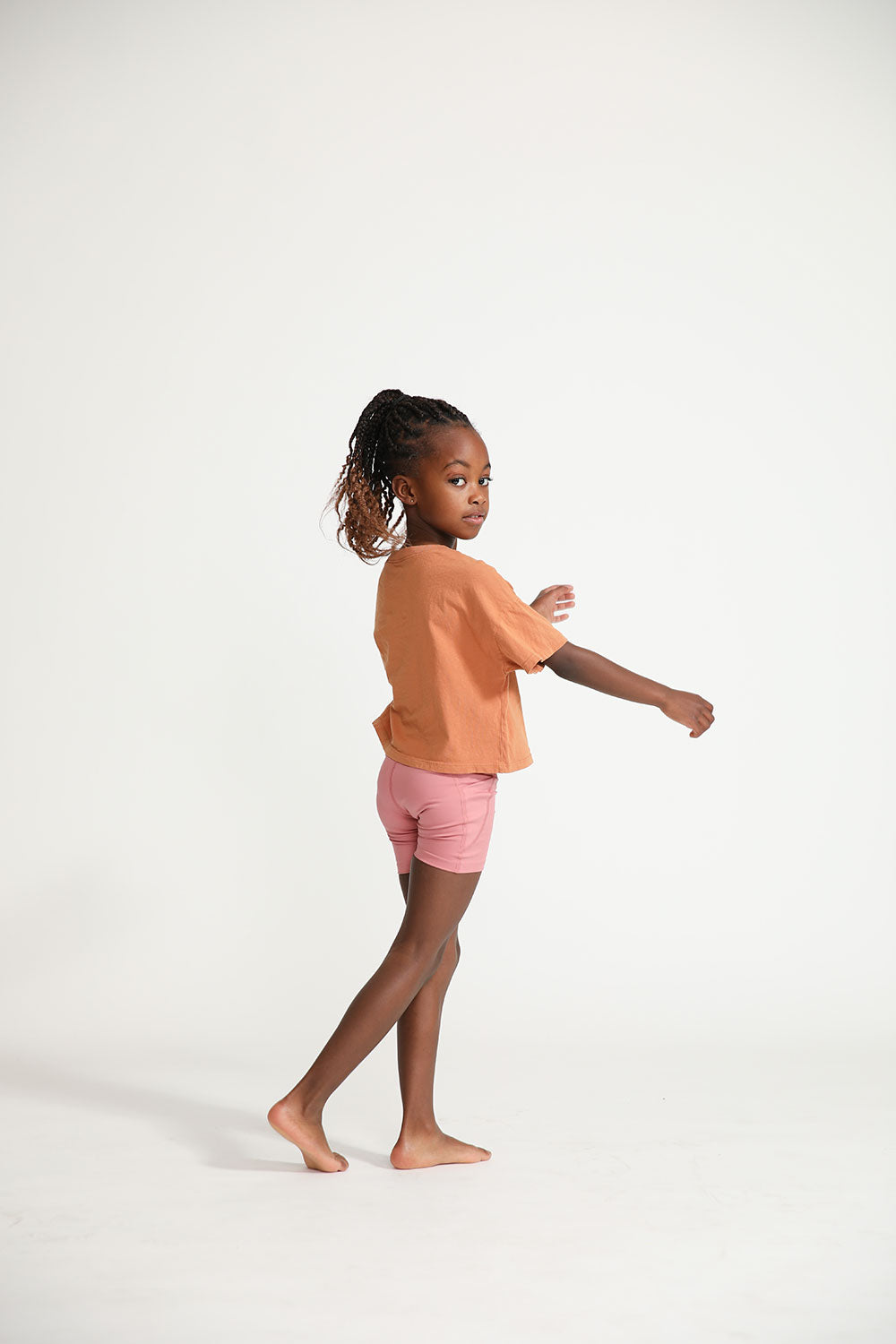 Young girl wearing Everyway kids activewear. Featuring Daily Tee in Meerkat.