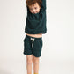 Young boy wearing Everyway kids activewear. Featuring Core Sweat Shorts in Pine.