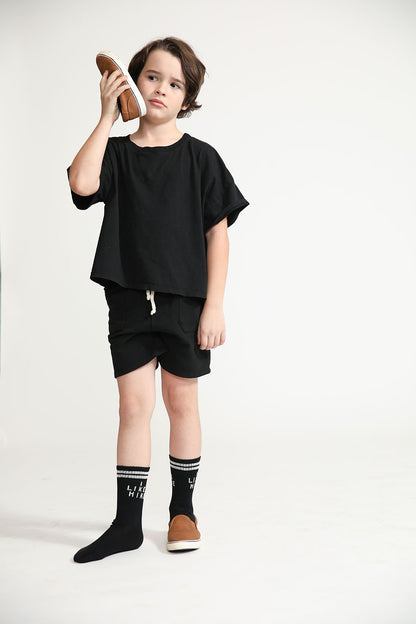 Young boy wearing Everyway kids activewear. Featuring Daily Tee in Black.