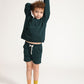 Young boy wearing Everyway kids activewear. Featuring Core Sweat Shirt in Pine.